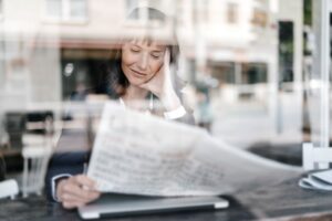 Image of a lady reading a newspaper